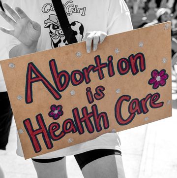 one protest sign on the left that reads pray to end abortion and one on the right that reads abortion is health care one protest sign on the left that reads pray to end abortion and one on the right that reads abortion is health care