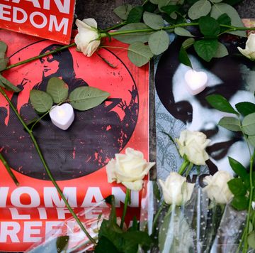 memorial photos of mahsa amini and white roses