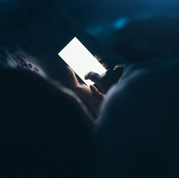 phone screen woman scrolling on her phone in the dark
