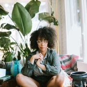 Young Woman Meditating in Home