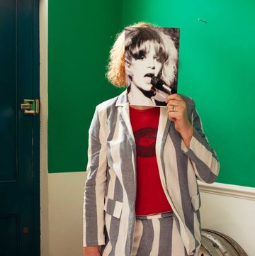 gina birch holds a photo of herself