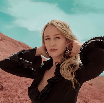 margo price stands in front of a red sand mountain