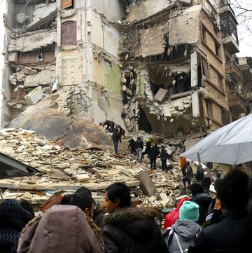 onlookers watch as rescue teams look for survivors under the rubble of a collapsed building after an earthquake in the regime controlled northern syrian city of aleppo on february 6 2023 onlookers watch as rescue teams look for survivors under the rubble of a collapsed building after an earthquake in the regime controlled northern syrian city of aleppo on february 6 2023